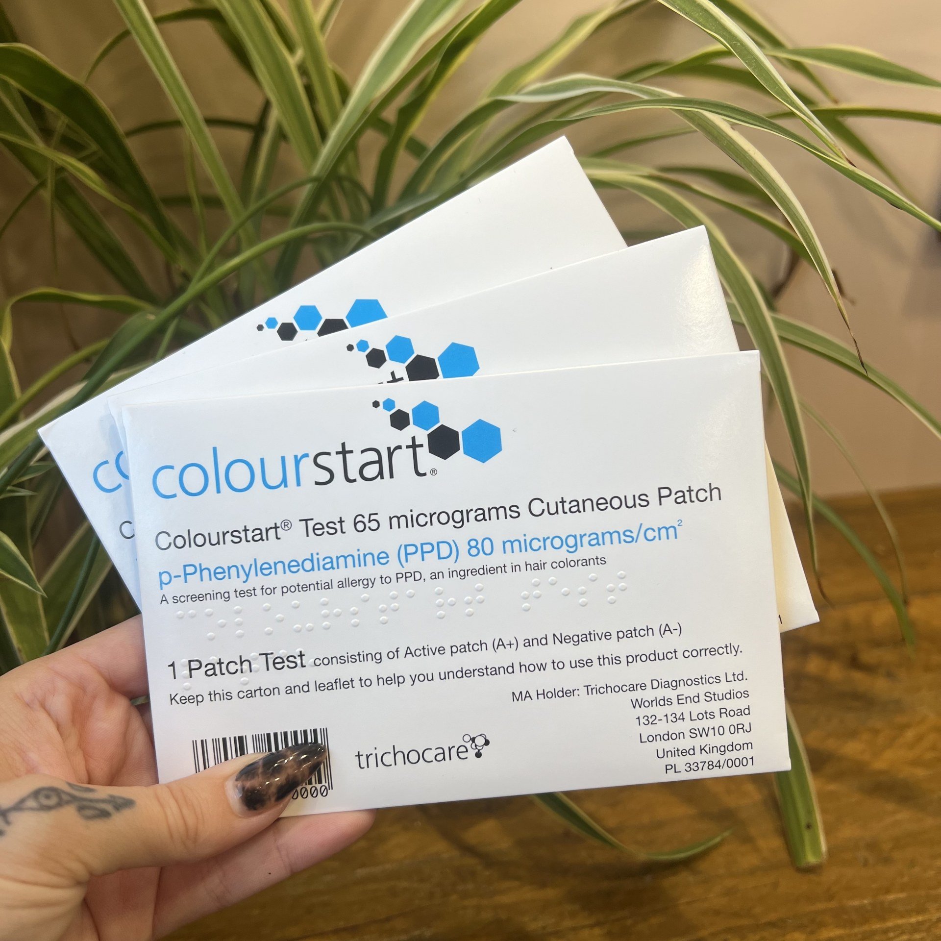 Someone holds three Colourstart Allergy Patch Tests